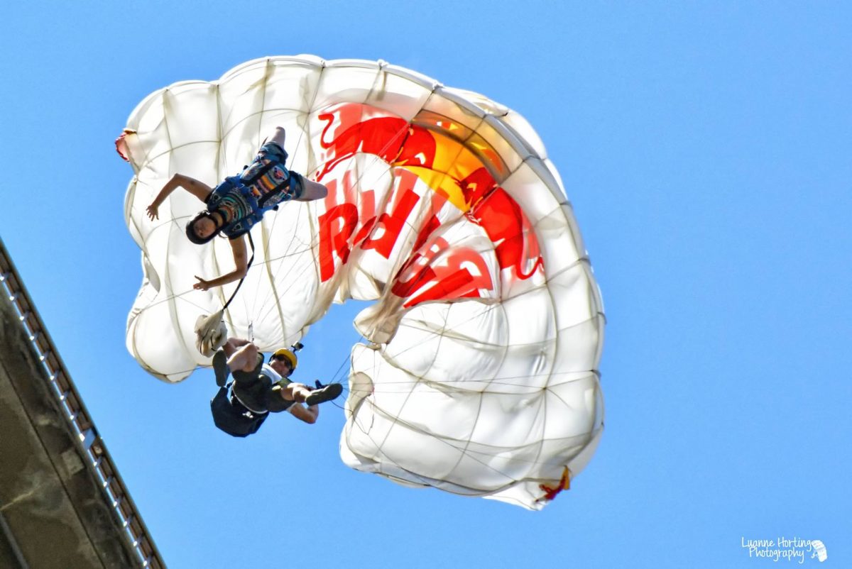 A photo of Miles Daisher just as his parachute is inflating from a BASE jump.