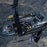 Jumpers exit a helicopter in wingsuits at Red Bull Aces