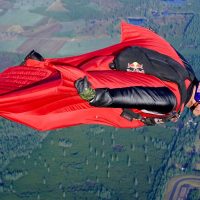 Luke Aikins flying in his red wingsuit.