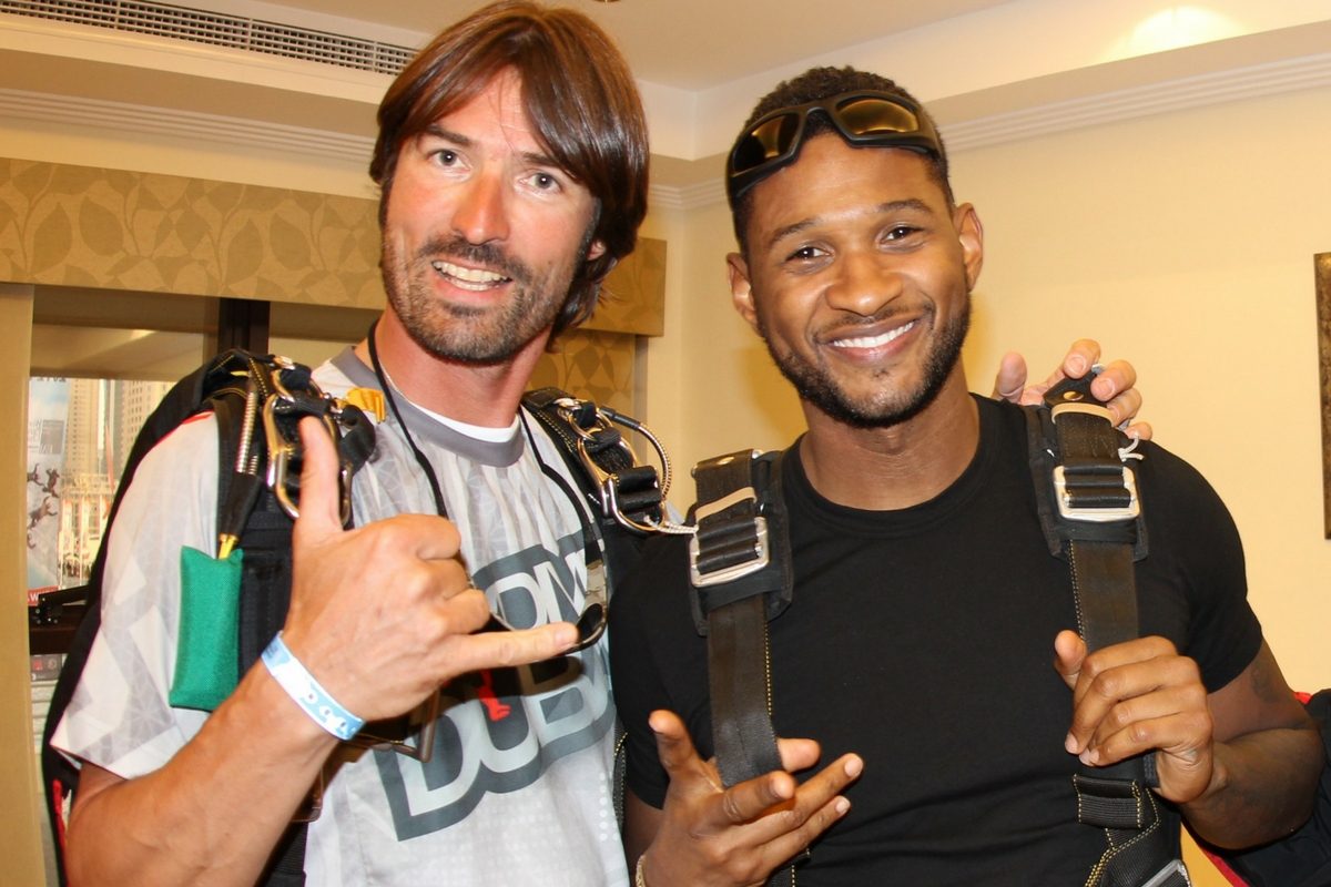 Frank poses with musician, Usher before making a skydive. 