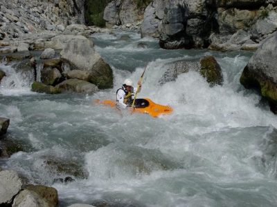 James kayaking through whitewater rapids.