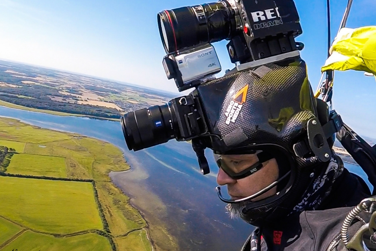 A closeup photo of Juan flying under canopy while wearing his camera helmet.