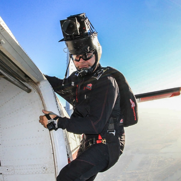 Juan on the side of a Twin Otter about to jump.