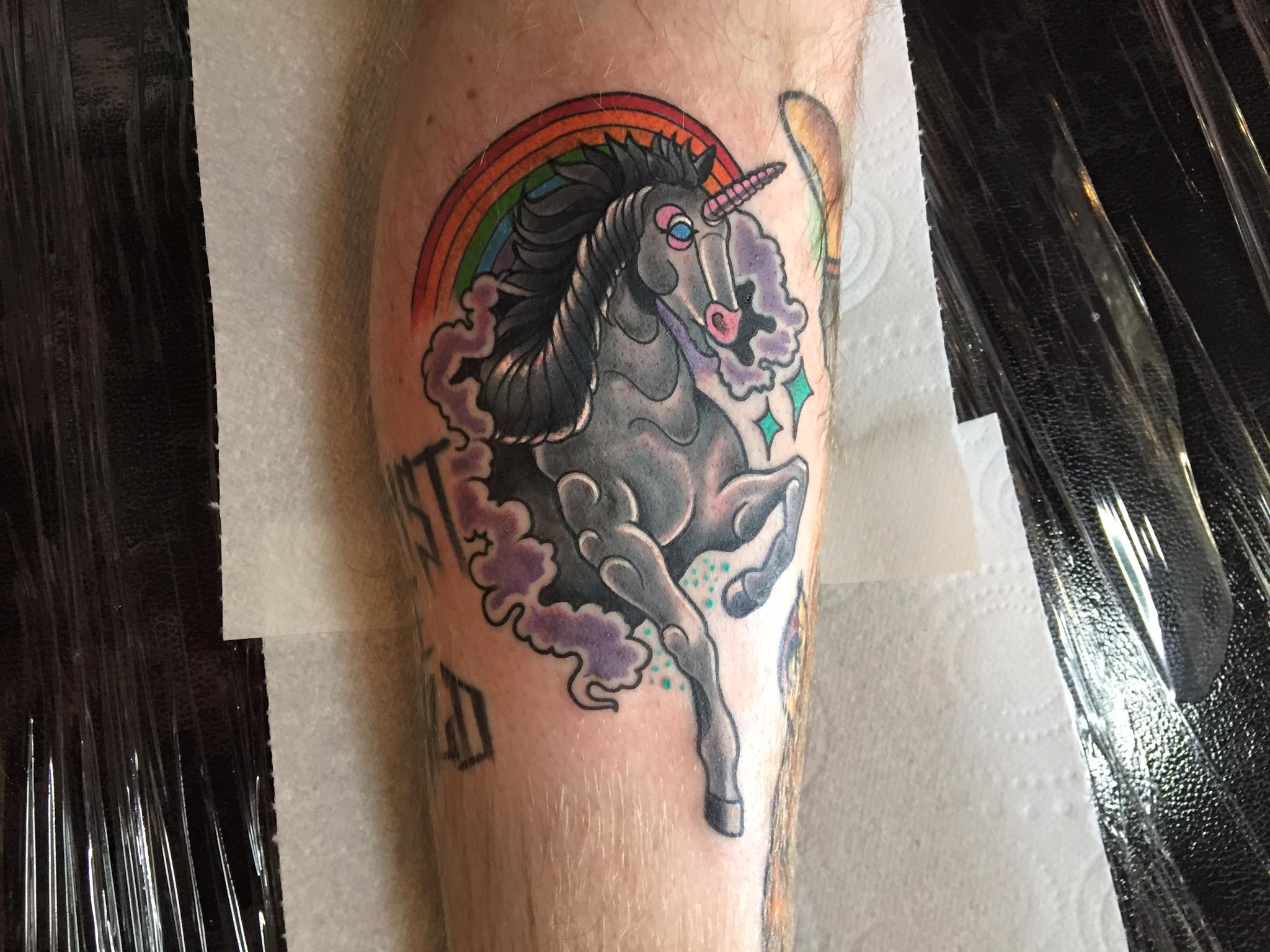 A unicorn tattoo on the back of Macca's calf. 