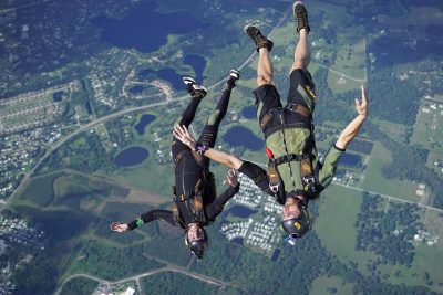 Two jumpers flying in a head to earth position on a skydive.