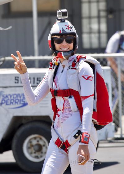 Roberta gives the peace sign while walking to the plane. 