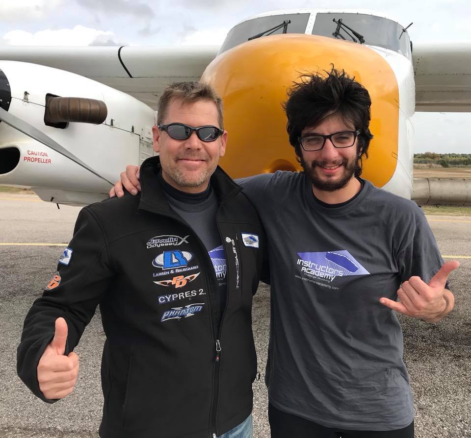 Marcus gives a thumbs up with one of his students in front of one of the planes at Skydive Spain.