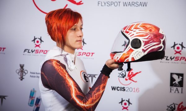 Olga Bakulina looks at her reflection from the glass shield of her helmet.