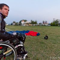 Alex getting into his wheelchair after a skydive