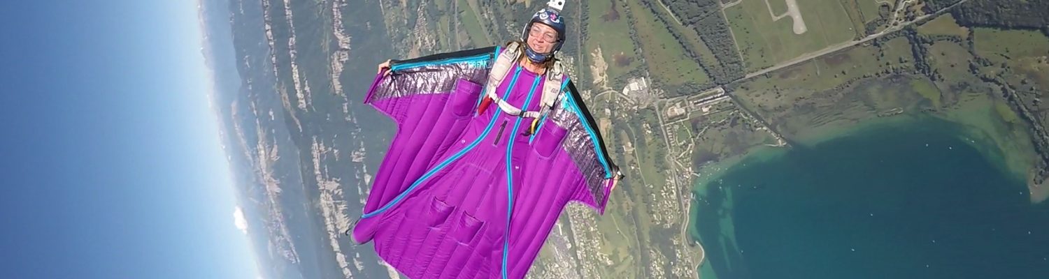 Marine geeks the camera while flying in her wingsuit thousands of feet in the sky