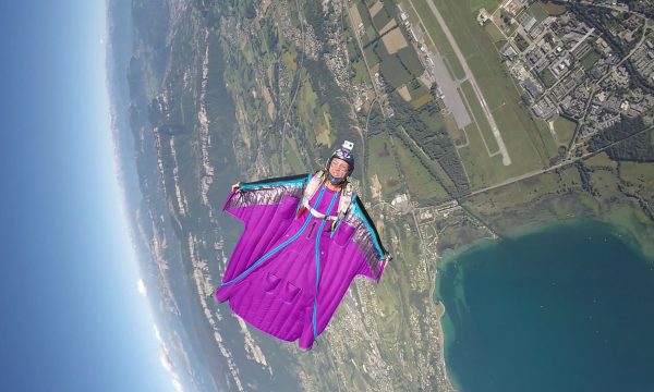 Marine flying her purple Squirrel wingsuit across the sky