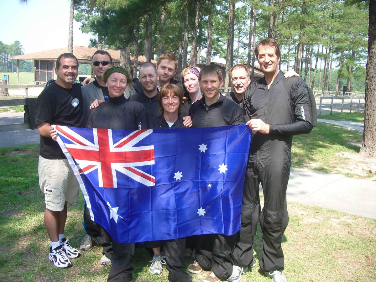 The Australian 8-Way Team poses with the Aussie flag while visiting Coach Kirk Verner at Skydive Paraclete XP