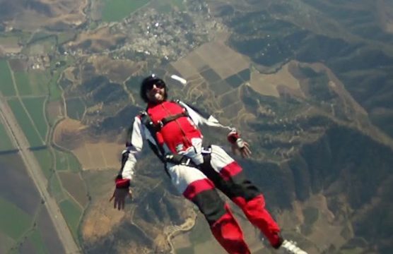 Eugenio tracking on his back during a skydive at Skydive Andes