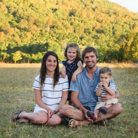 Eugenio sits with his family