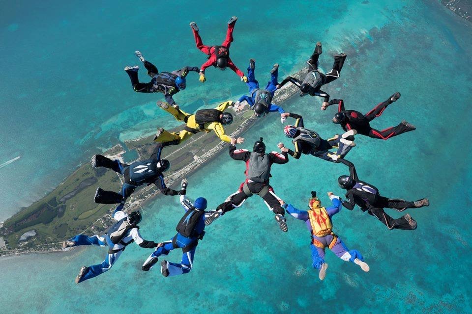 Regan Tetlow and a group of skydivers jump above the Maldives