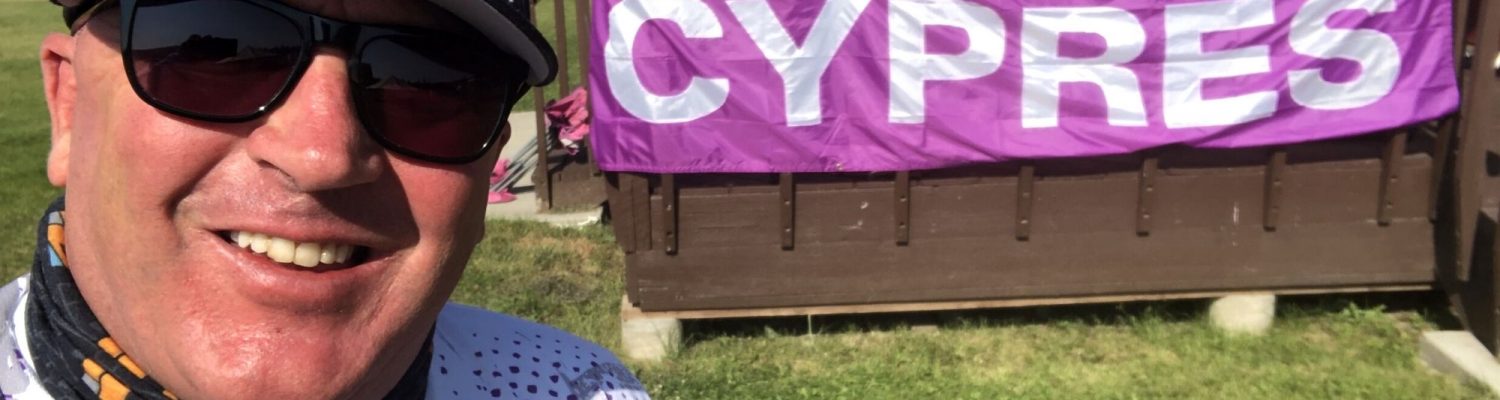 Regan Tetlow takes a selfie in front of a CYPRES banner