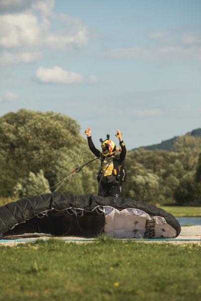 Cornelia raises her hands in the air after landing. 