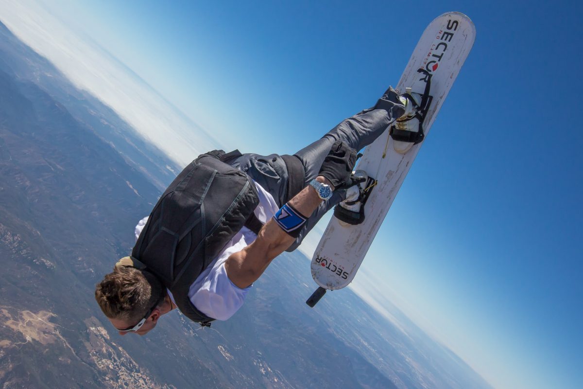 A photo of a skysurfer flying in a near head to earth body position