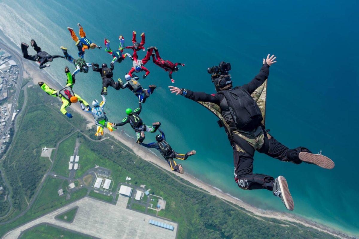 A photo of Craig O'Brien above a skydiving formation