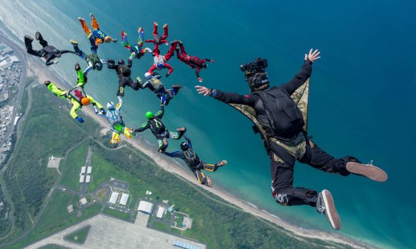 A photo of Craig O'Brien above a skydiving formation