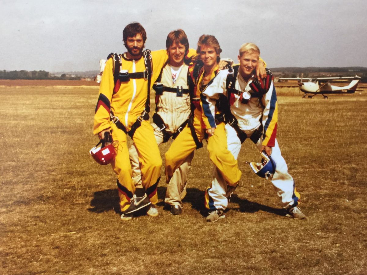 Pete poses with his family while all are wearing jumpsuits