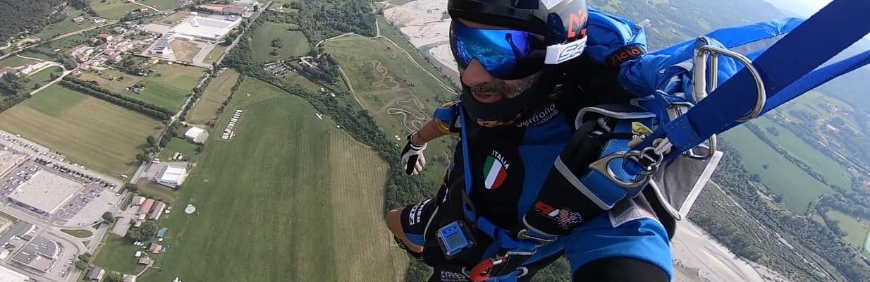 Vito smiles under canopy while getting ready for his final approach under parachute