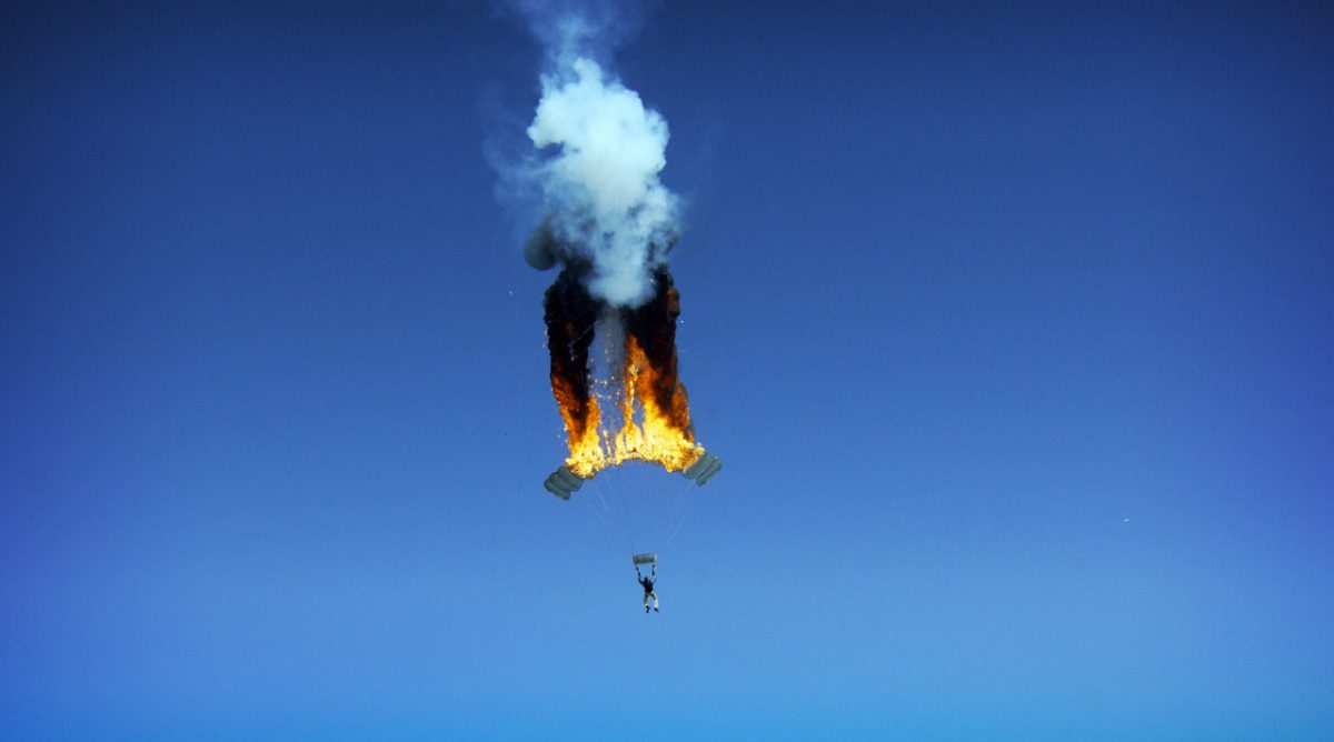 Joe Jennings photographs a stunt of a parachute on fire.