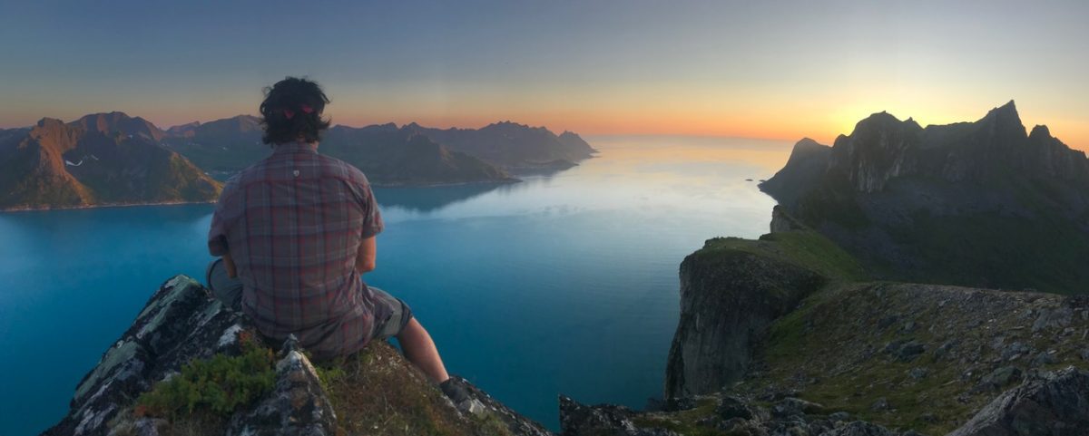 Jason Moledzki ponders life while sitting on a cliff at sunset