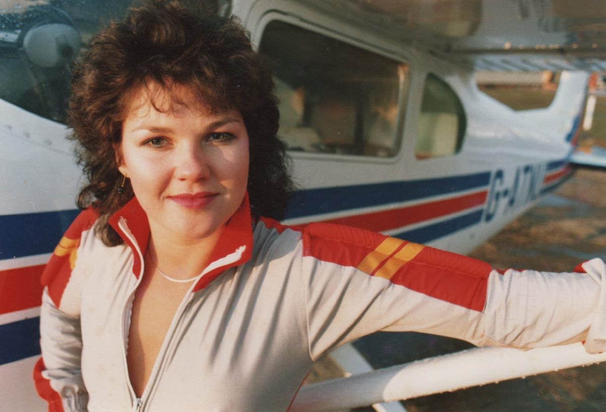 Lesley smiles in her jumpsuit in 1987