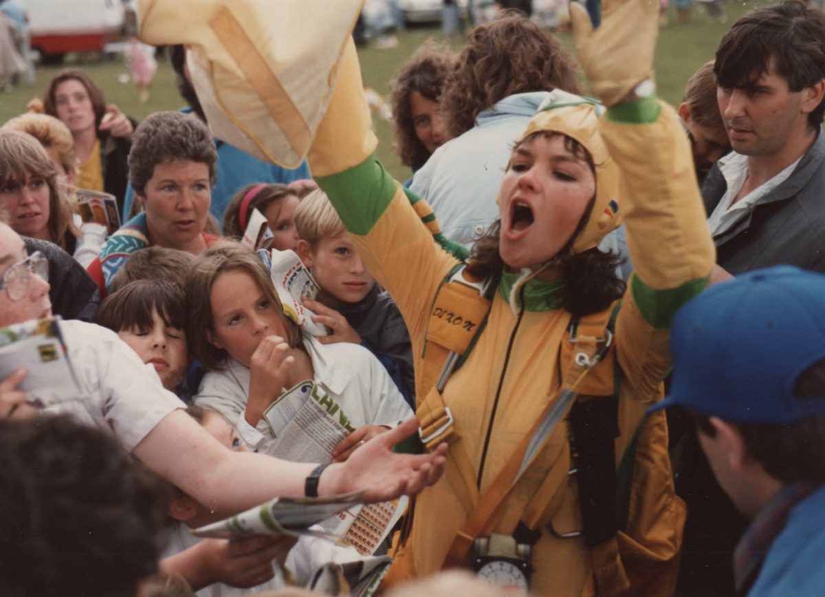 Lesley landing at a demo amongst excited children