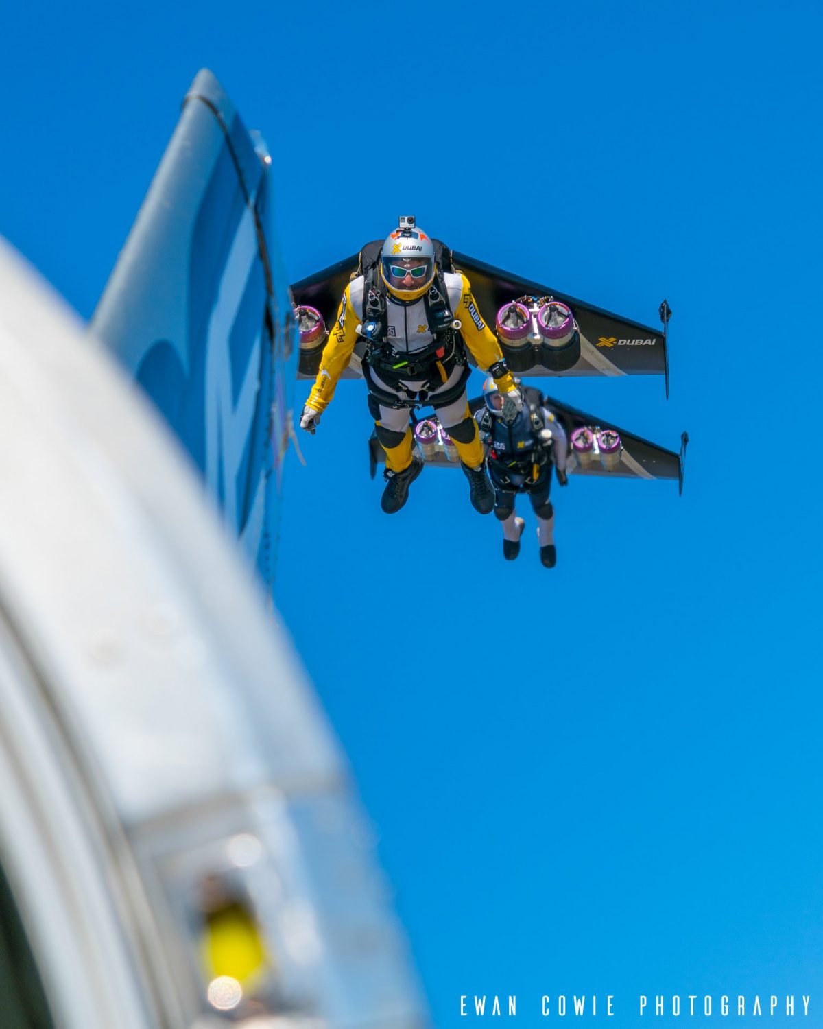 Fred and Vince flying in Jetman Wings alongside a Twin Otter